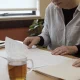 A support coordinator and a participant going through paperwork together at a table in an Australian community centre.